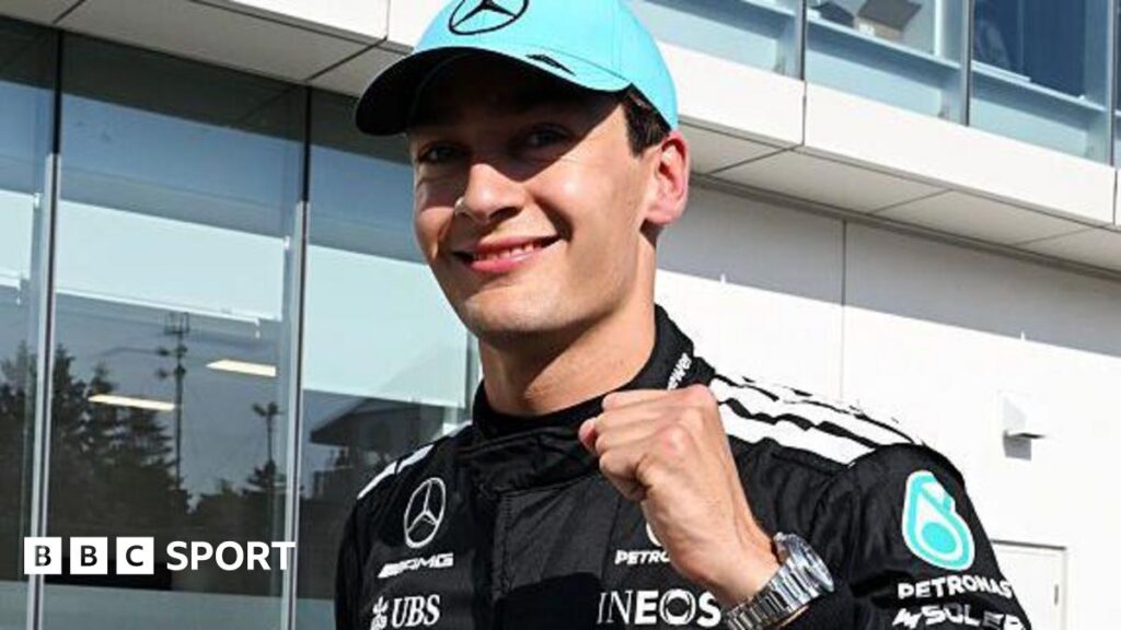 Mercedes' George Russell clenches his left fist in celebration and smiles at the camera after taking pole position for the Canadian Grand Prix