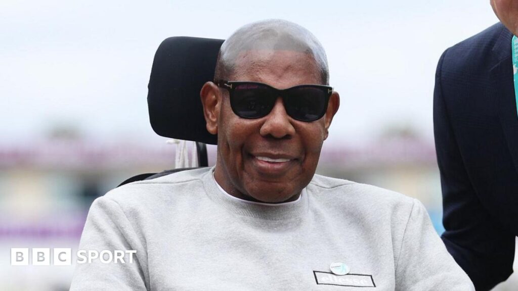 Former England and Gloucestershire bowler David Lawrence wearing sunglasses while sitting in a wheelchair