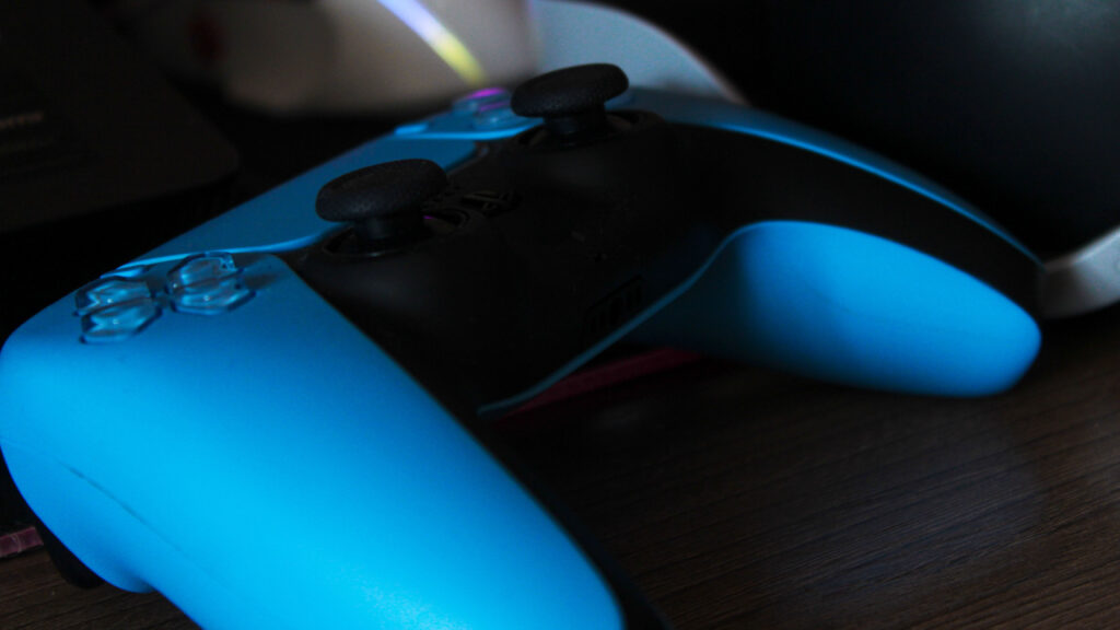 PlayStation DualSense controller in blue lighting