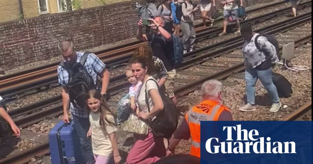Evacuated London train passengers forced to walk along tracks on hottest day of year | Rail transport