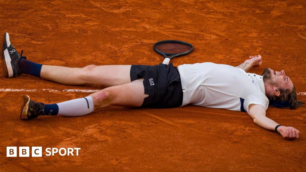 Alexander Bublik lays on the ground after defeating Jack Draper at the French Open