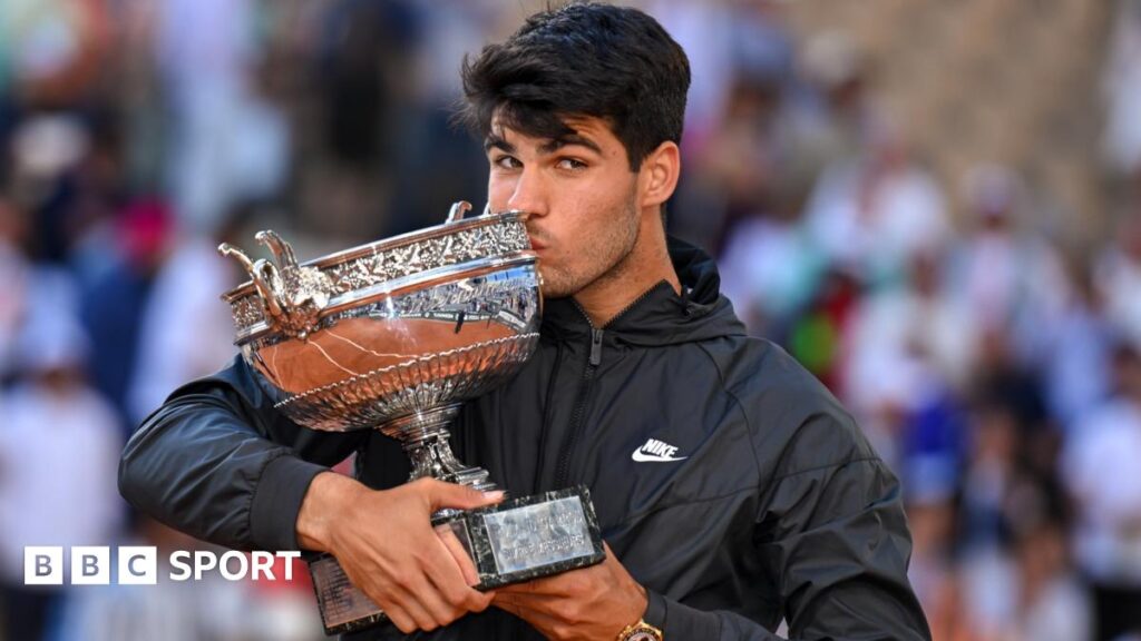 Carlos Alcaraz kisses the French Open trophy after his victory in the men's singles final in 2024