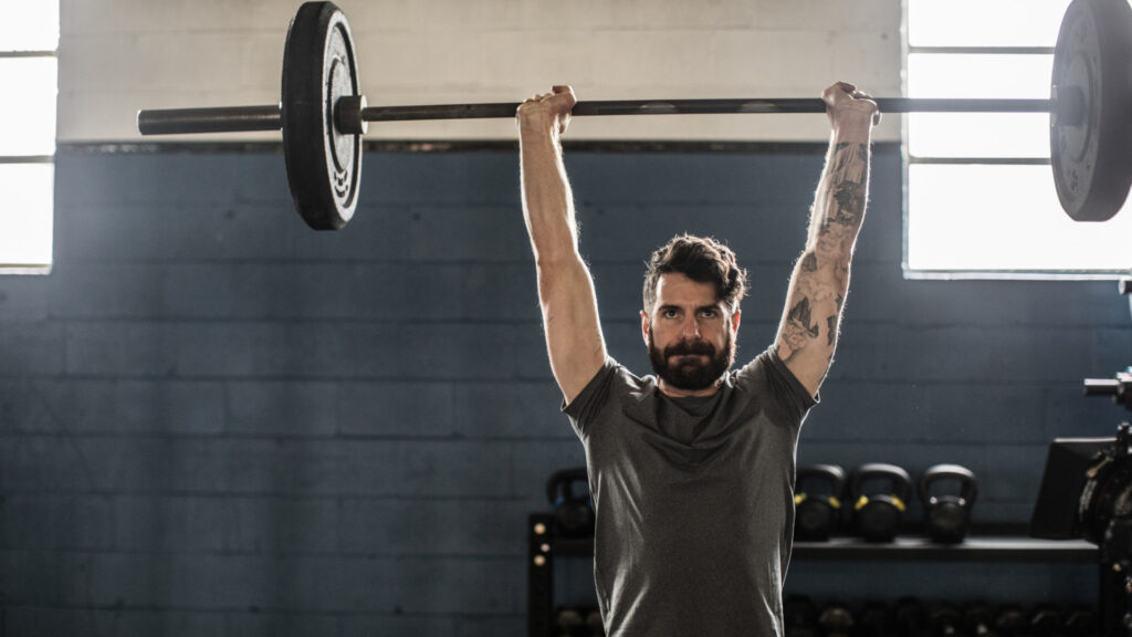 A man performing overhead press