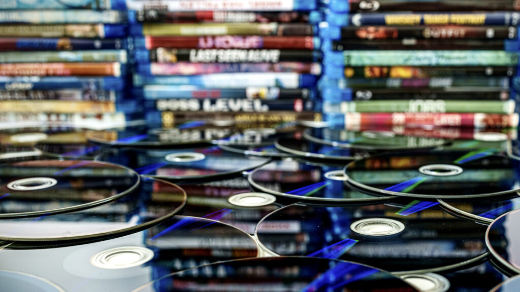 Series of Blu-ray discs with their cases in the background