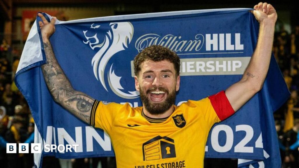 Jamie Brandon with the Scottish Premiership Play-off flag