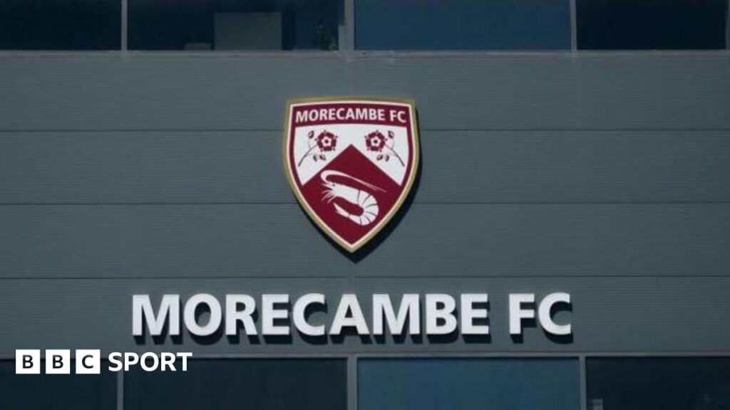Morecambe's logo at their Mazuma Stadium home