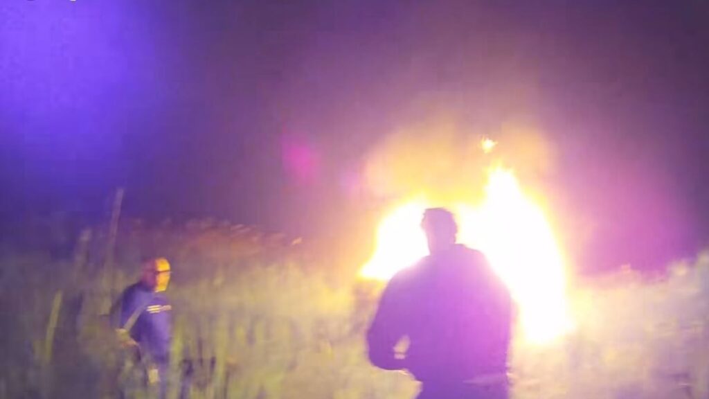 Police rescue 68-year-old woman from burning car after it flips over on highway