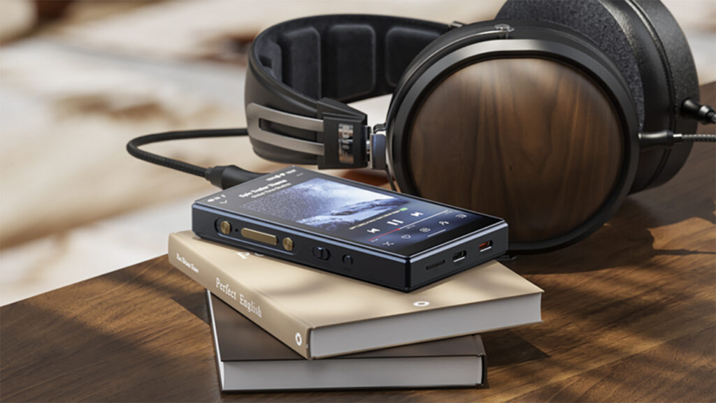 FiiO M21 on stack of books on table top with headphones behind