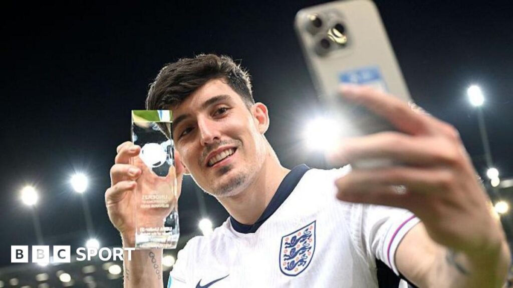 Tino Livramento takes a selfie while holding his player-of-the-match award