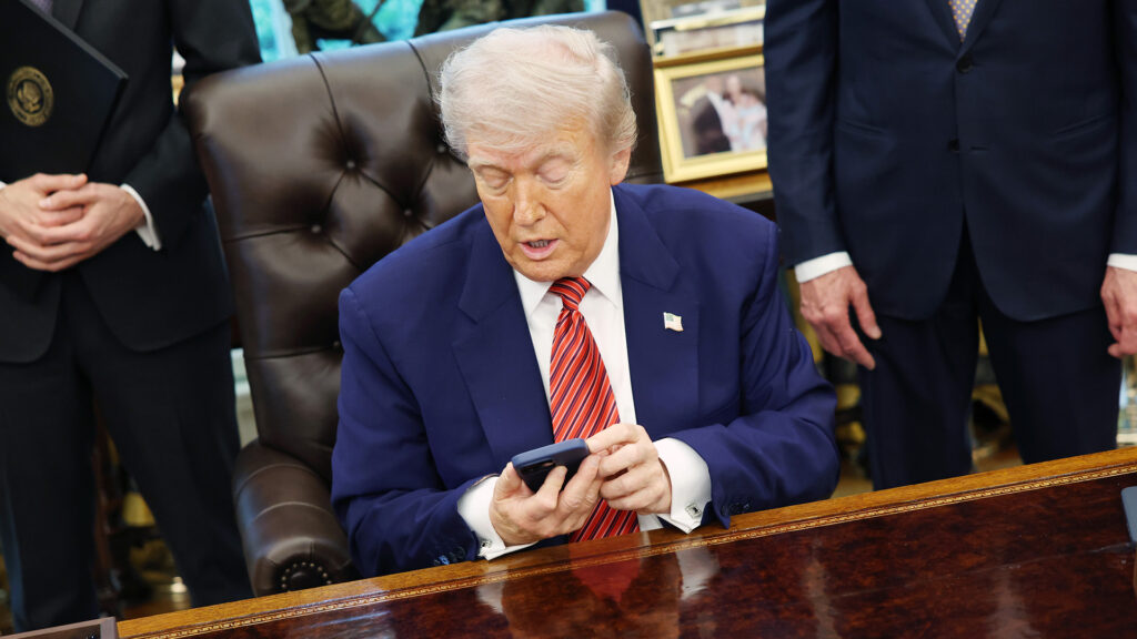 Donald Trump in Oval Office using a mobile phone