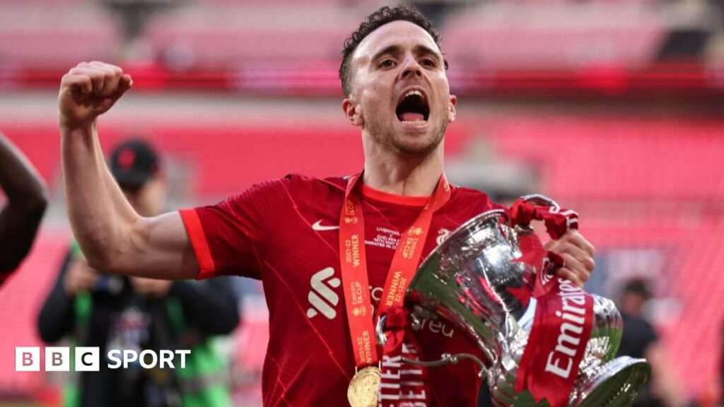 Diogo Jota celebrates with the FA Cup trophy following Liverpool's win over Chelsea in 2022
