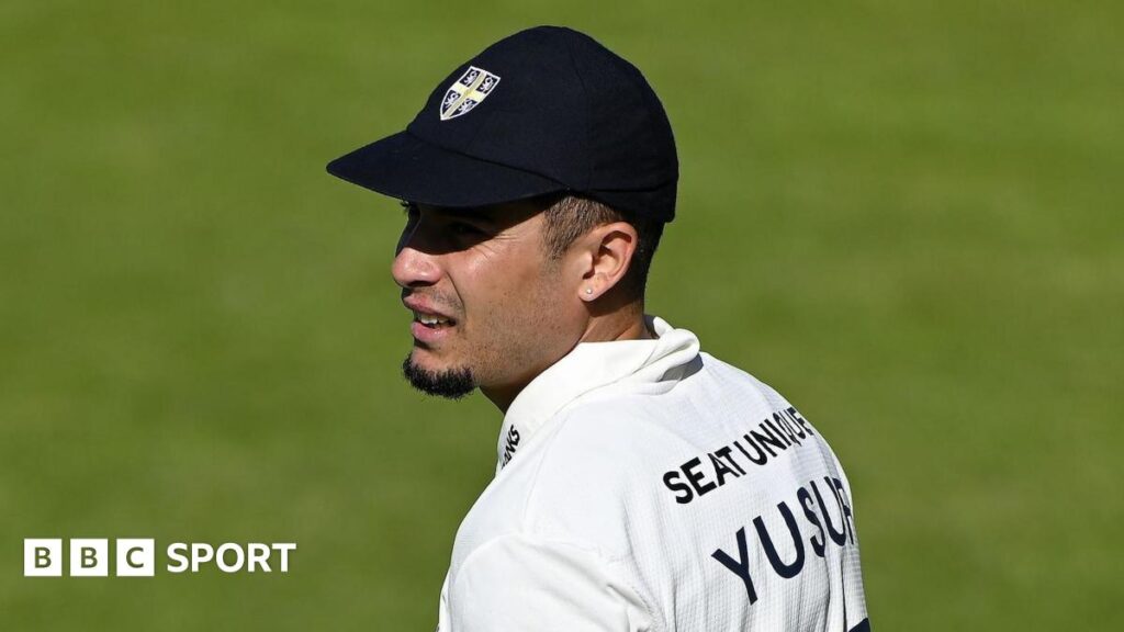 Codi Yusuf, wearing a Durham cap, in the field during a Championship match