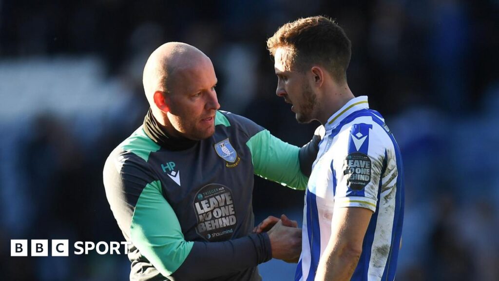 Henrik Pedersen (left) talking to former Sheffield Wednesday player Will Vaulks on the pitch