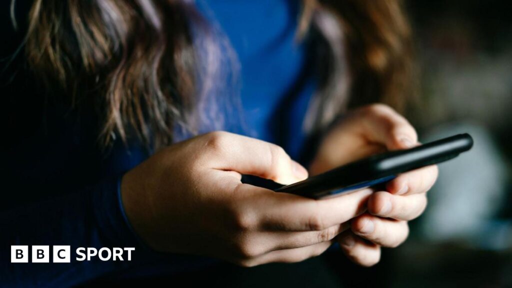 A woman holding a smart phone
