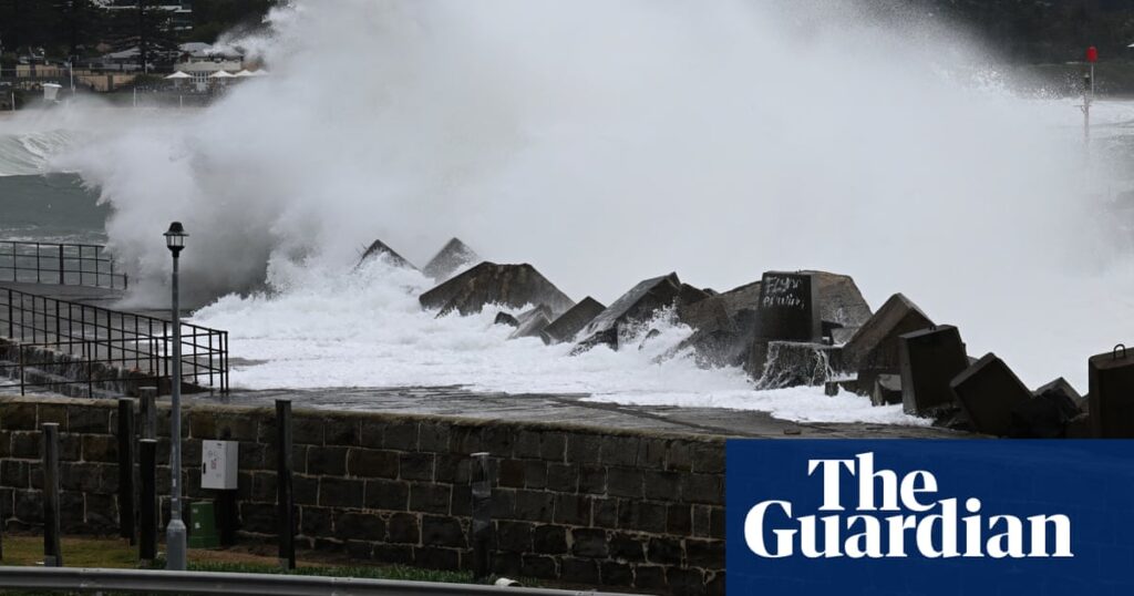 NSW wild weather: dam spill heightens flood threat as storm wreaks havoc | Australia news