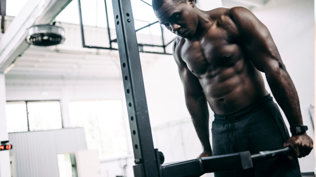 A man performing dips at the gym