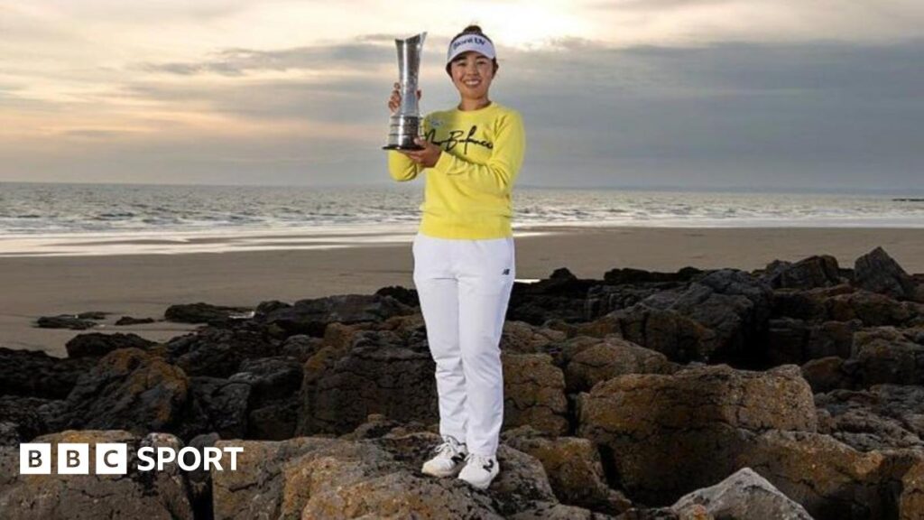 Miyu Yamashita holds her trophy at the Porthcawl coastline