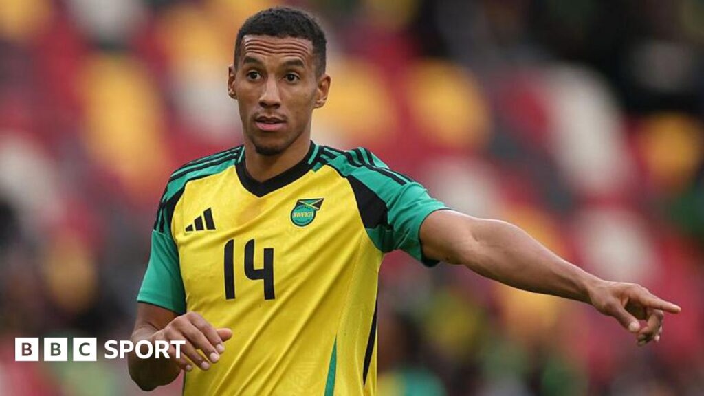Isaac Hayden points while playing for Jamaica