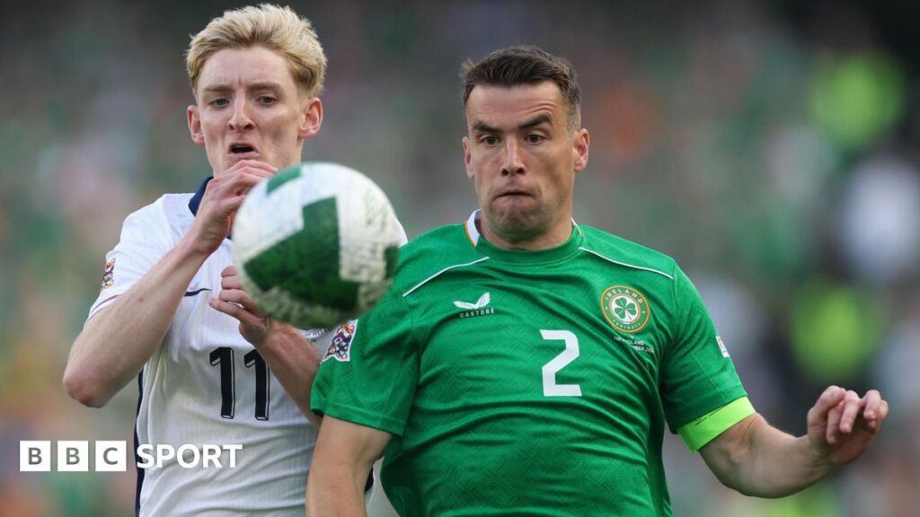Seamus Coleman battles for the ball with Anthony Gordon