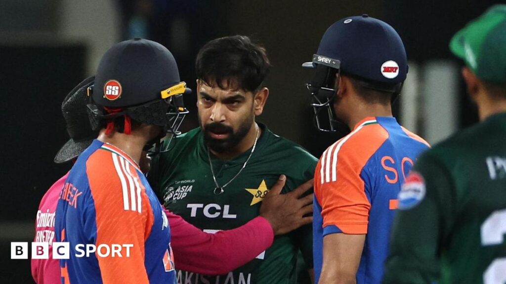 The umpire steps between Pakistan bowler Haris Rauf and India batter Abhishek Sharma