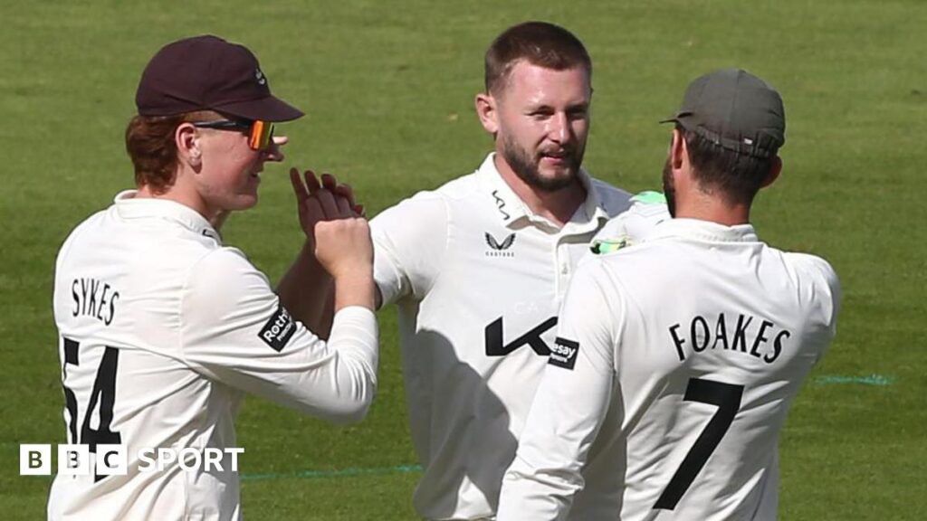 Gus Atkinson takes a wicket for Surrey