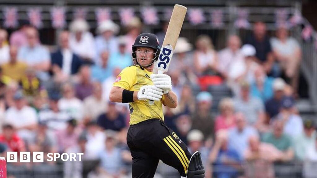 D'Arcy Short looks over his shoulder while holding the bat in the air during a match for Gloucestershire