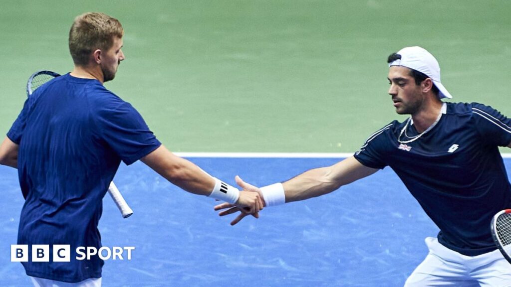 Julian Cash and Lloyd Glasspool shake hands during Davis Cup doubles match against Poland