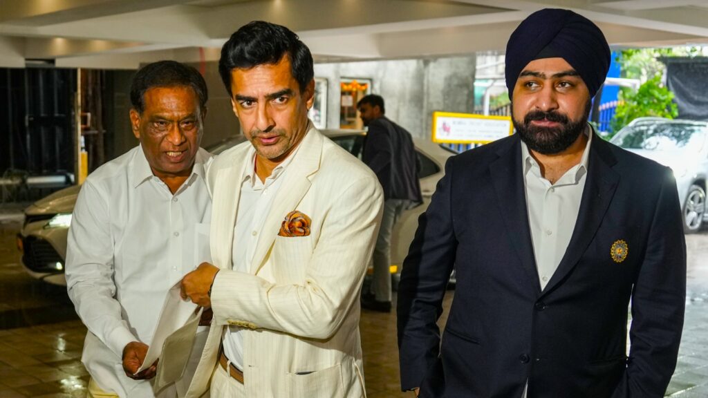 Former cricketer Mithun Manhas, center, and BCCI's joint secretary Prabhtej Singh Bhatia, right, arrive for the board's Annual General Meeting (AGM) at its headquarters, in Mumbai on Sunday. (PTI Photo)