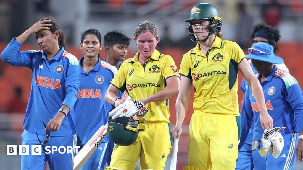 Beth Mooney and Annabel Sutherland of Australia leave the field after beating India in the first one-day international