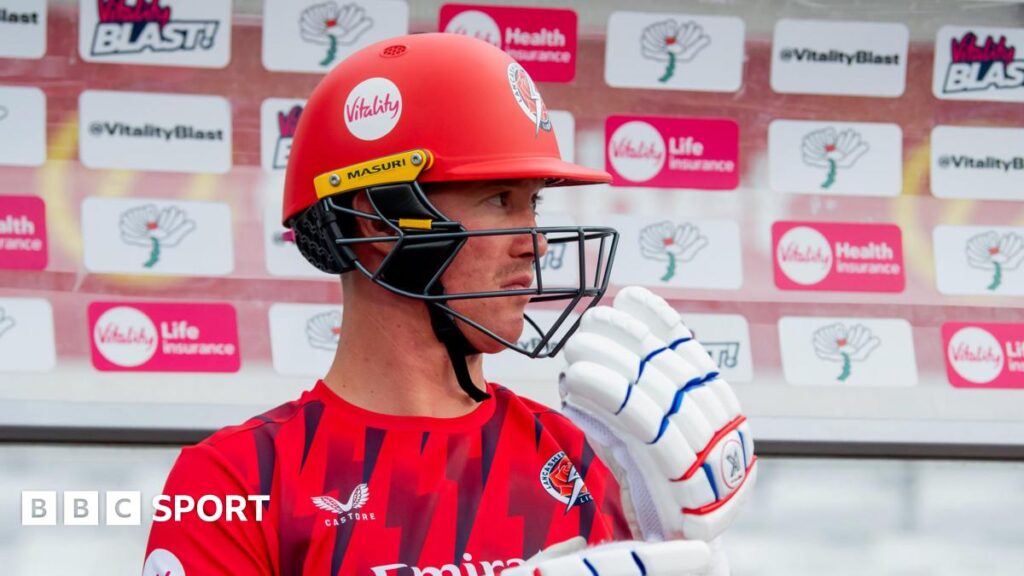 Keaton Jennings sitting in a T20 Blast dugout with his helmet and gloves on