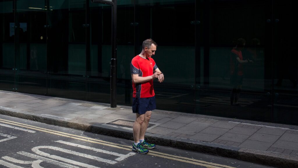 A man checks his fitness tracker
