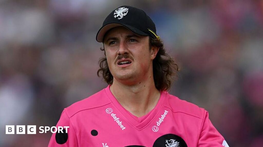 Tom Kohler-Cadmore walking on the field during a T20 match