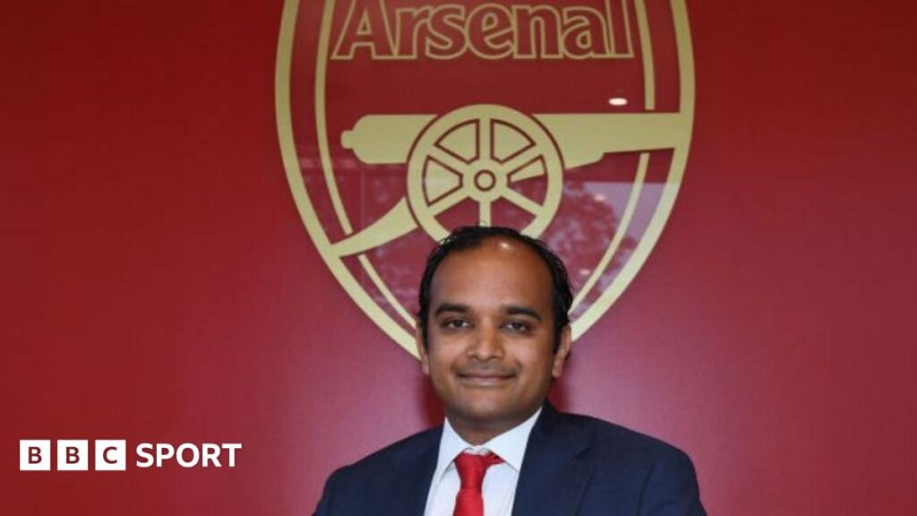 A close-up picture of Vinai Venkatesham looking focused in a suit and tie