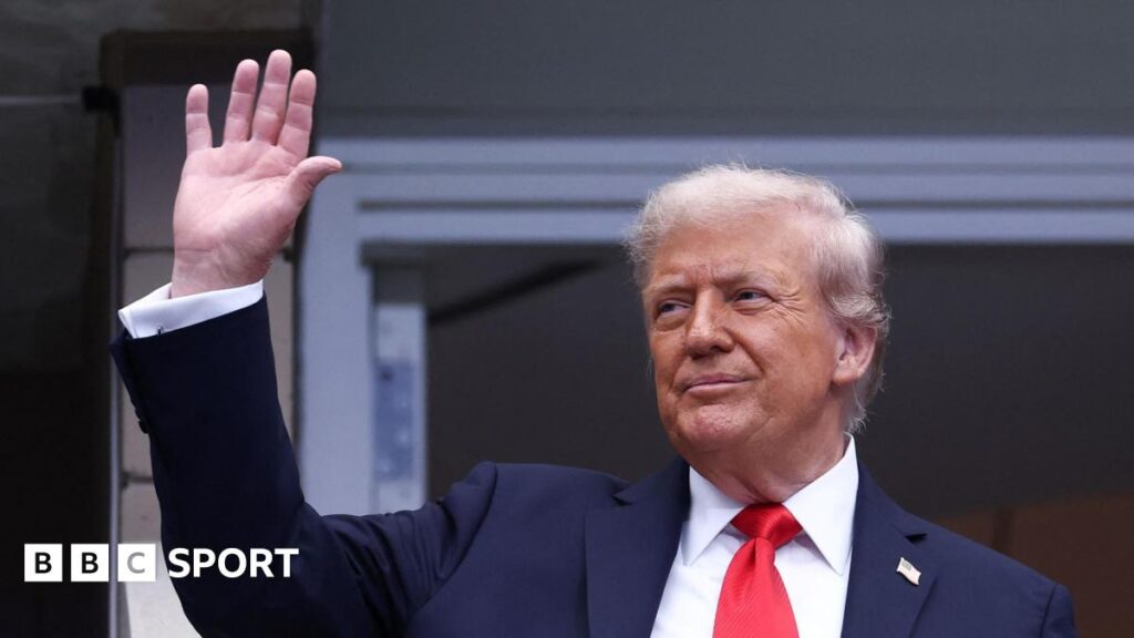 Donald Trump waves to fans at Arthur Ashe Stadium