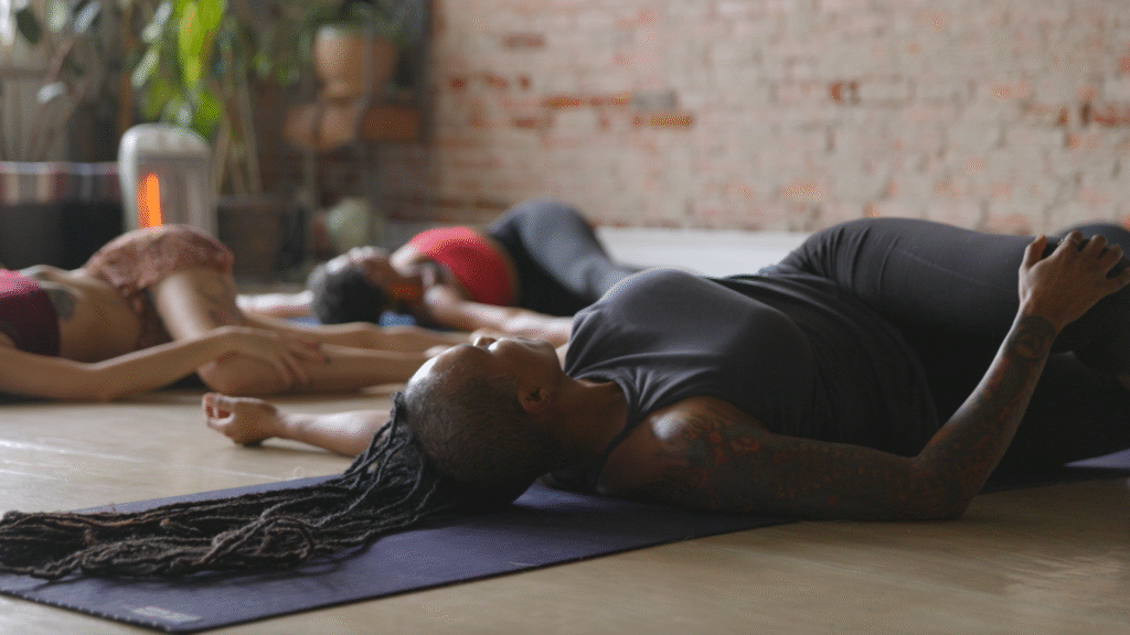 woman in supine twists, part of a yin yoga practice