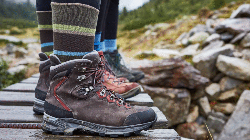 How to make your hiking boots last longer: 5 mistakes to avoid close up of hiking boots on a little wooden bridge