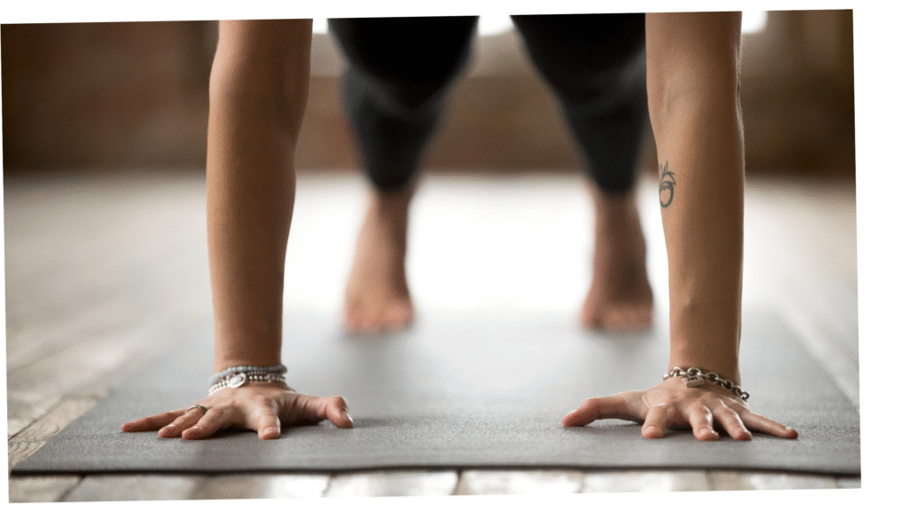 Woman yoga student practicing Plank Pose on a yoga mat