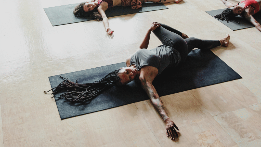 A woman in Reclined Twist, part of a morning yin yoga practice