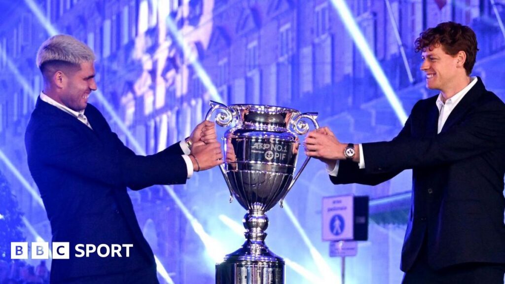 Carlos Alcaraz and Jannik Sinner pose with the ATP year-end number one trophy
